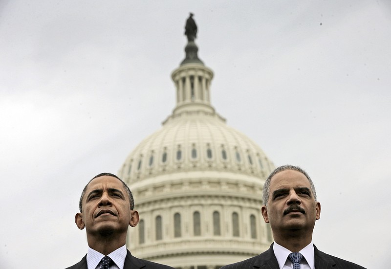 
              FILE - In this May 15, 2013 file photo, President Barack Obama sits with Attorney General Eric Holder during the 32nd annual the National Peace Officers Memorial Service on Capitol Hill in Washington. Obama has announced plans to improve Democrats’ down-ballot fortunes once he leaves office. He is launching an initiative with former Attorney General Eric Holder aimed at making Democratic gains when states redraw legislative district lines following the 2020 census.   (AP Photo/Pablo Martinez Monsivais)
            