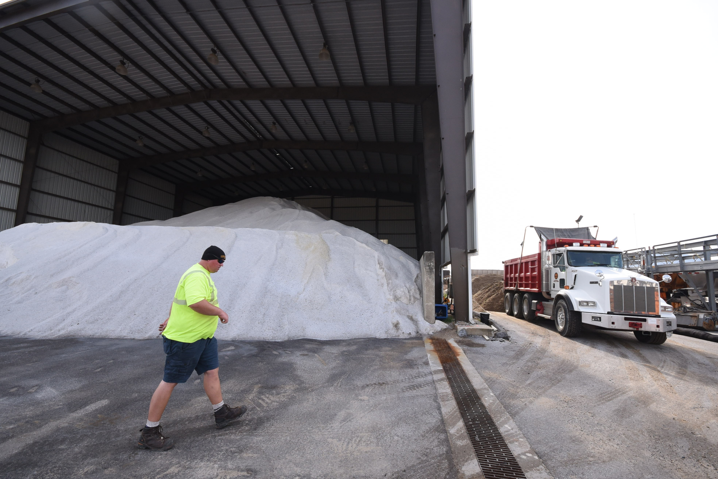 City truck driver Derrick Kilgore walks in front of salt reserves at the city yard just off E. 11th Street on Wednesday.