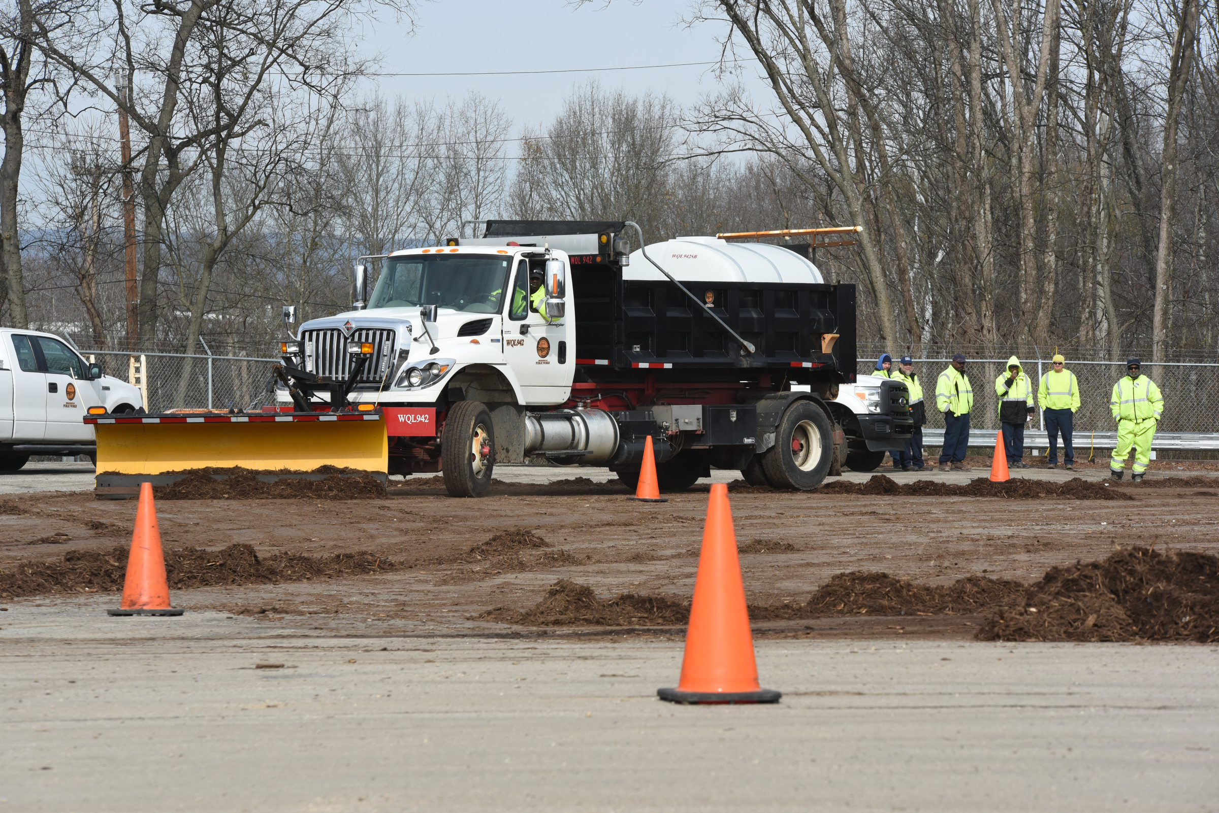 Street maintenance crews train with snow plows on multi-use trucks at the city's wood recycle yard on North Hawthorne Street.