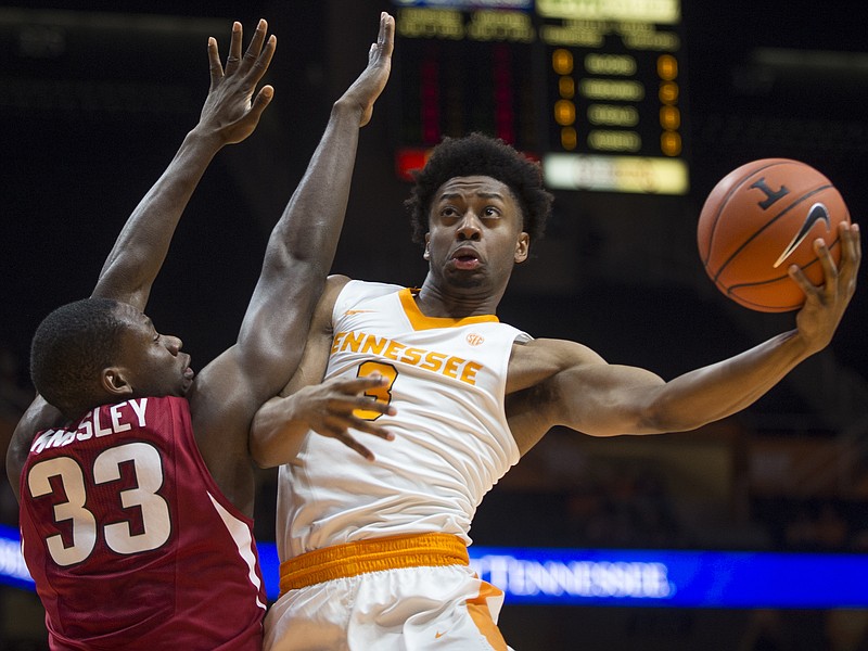 Tennessee's Robert Hubbs III attempts a shot past Arkansas' Moses Kingsley (33) during the first half Tuesday in Knoxville.