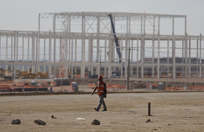 
              A man walks past the nearly deserted construction site, as workers shut down operations and remove equipment a day after Ford announced the cancellation of plans to build a $1.6 billion auto manufacturing plant on the site, in Villa de Reyes, outside San Luis Potosi, Mexico, Wednesday, Jan. 4, 2017. Ford's cancellation, which costs the region thousands of projected jobs, has sounded alarms throughout the country and sent Mexico's currency tumbling by nearly 1%. (AP Photo/Rebecca Blackwell)
            