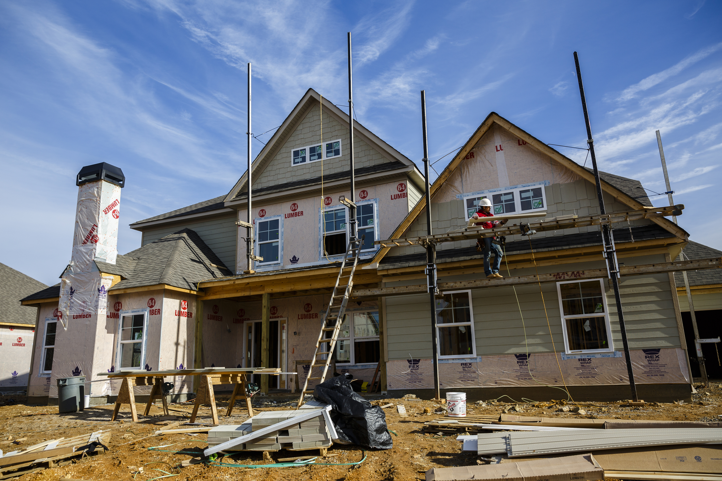 A worker adds siding to a home under construction in the Meadowstream subdivision on Wednesday, Jan. 4, 2016, in Ooltewah, Tenn. Ooltewah and East Brainerd are two of the region's fastest developing residential areas.
