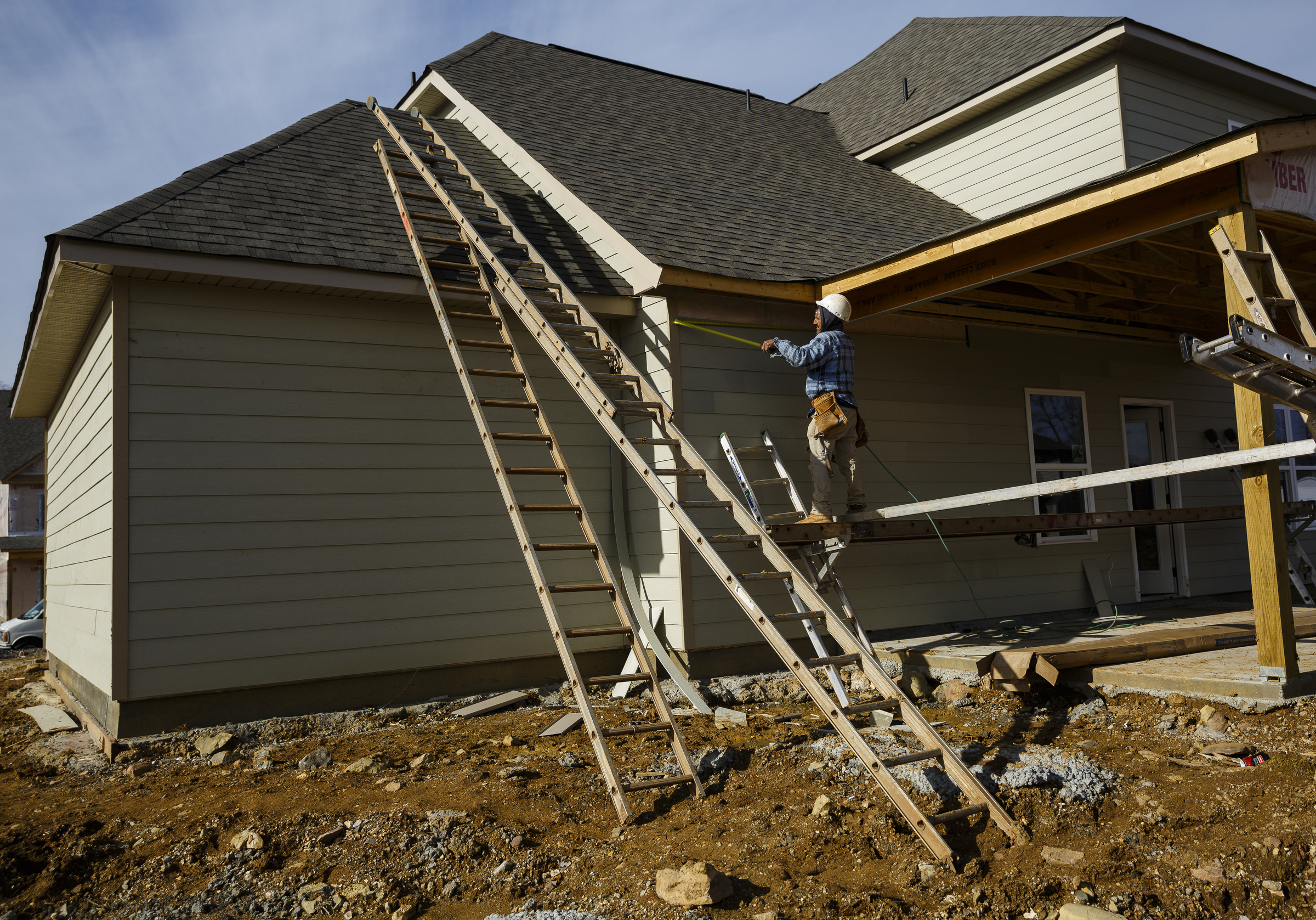 A worker adds siding to a home under construction in the Meadowstream subdivision on Wednesday, Jan. 4, 2016, in Ooltewah, Tenn. Ooltewah and East Brainerd are two of the region's fastest developing residential areas.