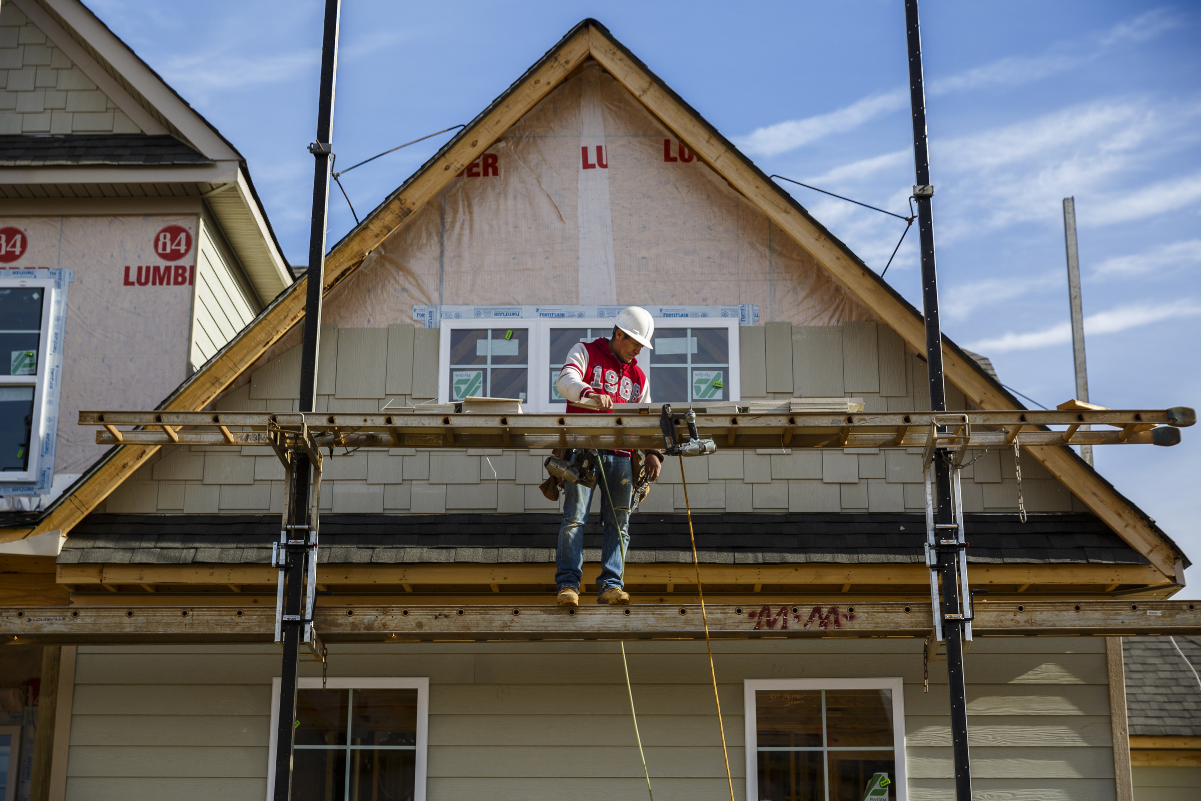 A worker adds siding to a home under construction in the Meadowstream subdivision on Wednesday, Jan. 4, 2016, in Ooltewah, Tenn. Ooltewah and East Brainerd are two of the region's fastest developing residential areas.