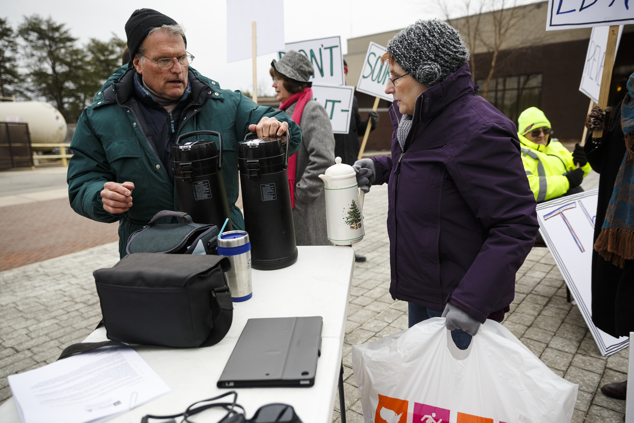 Jonathan Stephens, left, and Myra Stephens arrive with coffee and donuts for demonstrators protesting the privatization of the Fall Creek Falls State Park's hospitality services outside of the park's inn on Thursday, Jan. 5, 2017, near Spencer, Tenn. The Tennessee State Employees Association organized the protest, which coincided with a meeting by state officials and potential bidders at the park's inn.