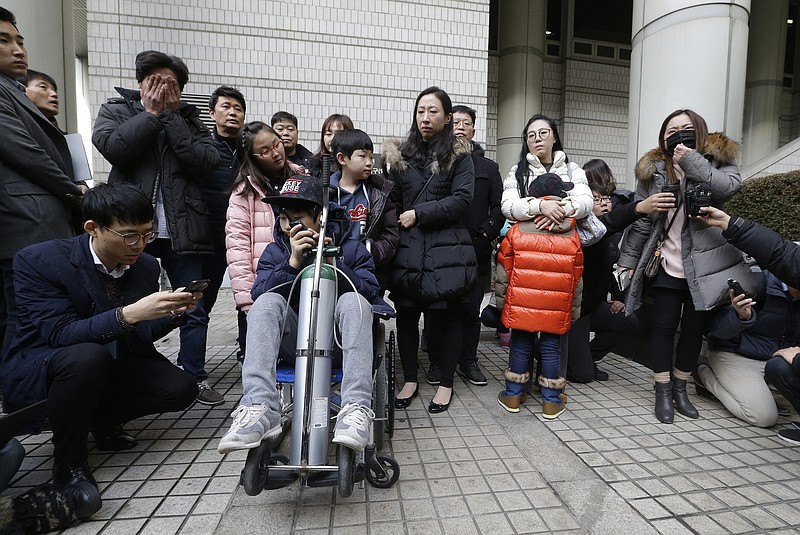 
              Victims and their families of toxic humidifier disinfectants hold a press conference against a court's sentence at the Seoul Central District Court in Seoul, South Korea, Friday, Jan. 6, 2017. A South Korean court has sentenced the former head of Oxy Reckitt Benckiser to seven years in prison after the company's disinfectant for humidifiers killed scores of people. (AP Photo/Ahn Young-joon)
            