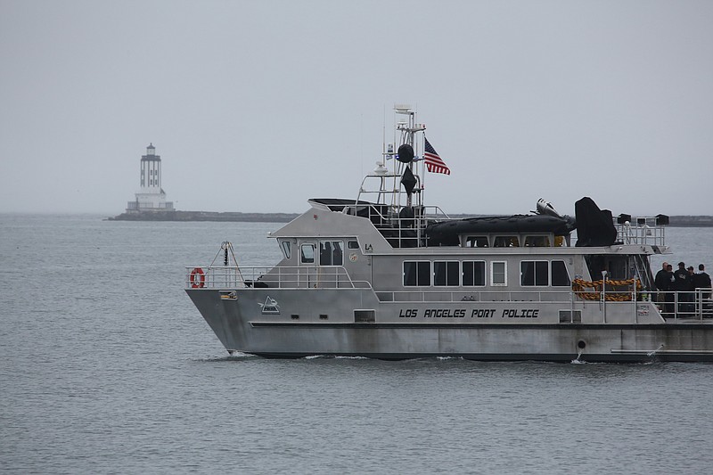 
              A rescue boat searches the waters around the Port of Los Angeles breakwater Thursday, Jan. 5, 2017, morning in heavy fog after numerous cruise ship passengers reported seeing a helicopter go down in the area Wednesday night. Coast Guard officials searching the waters of Los Angeles Harbor say there's no sign of a two-person helicopter that went missing after taking off from an LA-area airport. (Chuck Bennett/The Daily Breeze via AP)
            