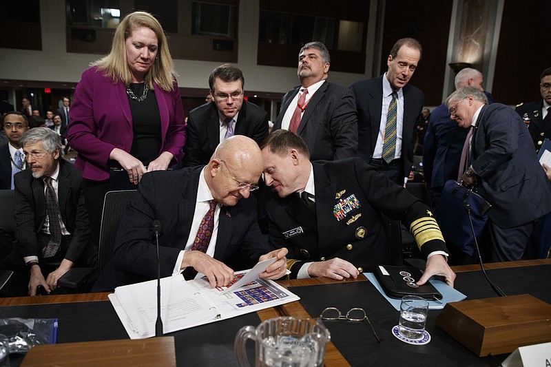 Director of National Intelligence James Clapper, left, talks with National Security Agency and Cyber Command chief Adm. Michael Rogers on Capitol Hill in Washington, Thursday, Jan. 5, 2017, at the conclusion of a Senate Armed Services Committee hearing: "Foreign Cyber Threats to the United States." (AP Photo/Evan Vucci)