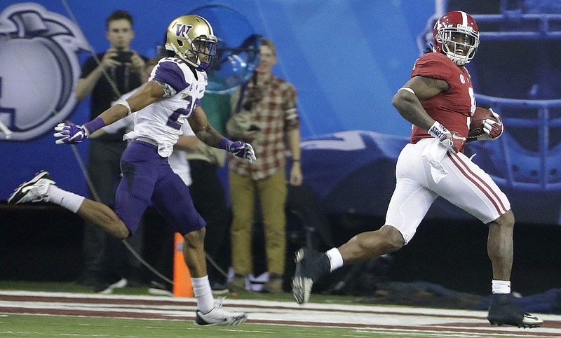 Alabama sophomore tailback Bo Scarbrough glances back at Washington defensive back Kevin King before finishing off a 68-yard touchdown run during last Saturday's 24-7 defeat of the Huskies in the Peach Bowl.
