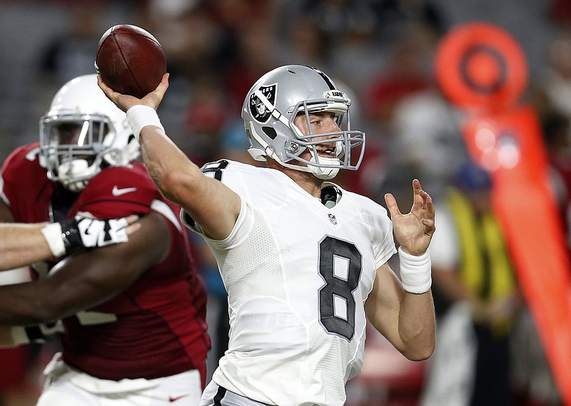 
              FILE - In this Aug. 12, 2016, file photo, Oakland Raiders quarterback Connor Cook (8) during an NFL preseason football game against the Arizona Cardinals in Glendale, Ariz. Cook is the first QB in NFL history to make his first start in a playoff game. (AP Photo/Rick Scuteri, File)
            