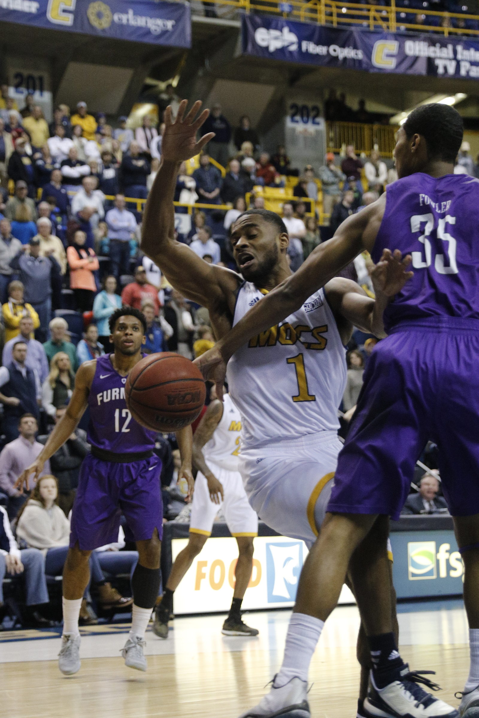 Furman guard Daniel Fowler shuts down UTC guard Greg Pryor's shot during the Mocs' home basketball game against Furman at McKenzie Arena on Saturday, Jan. 7, 2017, in Chattanooga, Tenn.