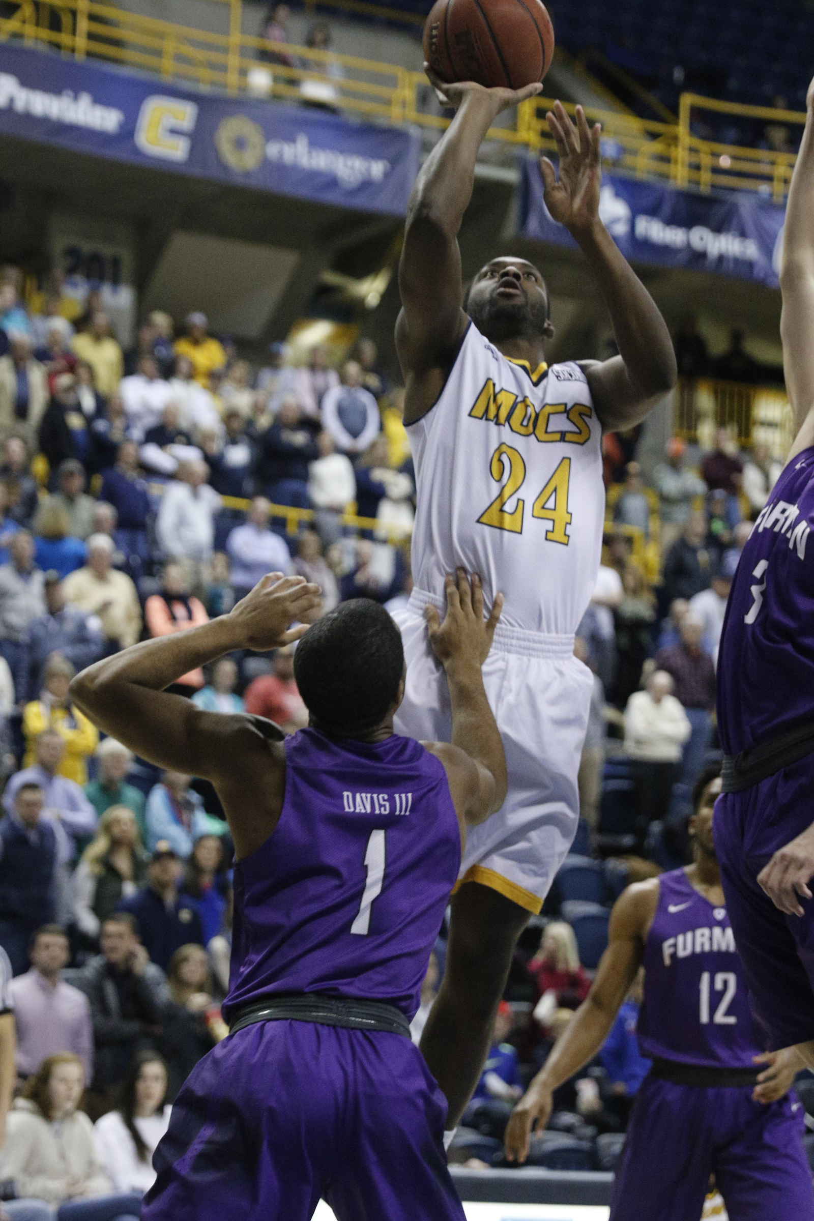 UTC guard Casey Jones shoots over Furman guard John Davis III during the Mocs' home basketball game against Furman at McKenzie Arena on Saturday, Jan. 7, 2017, in Chattanooga, Tenn.