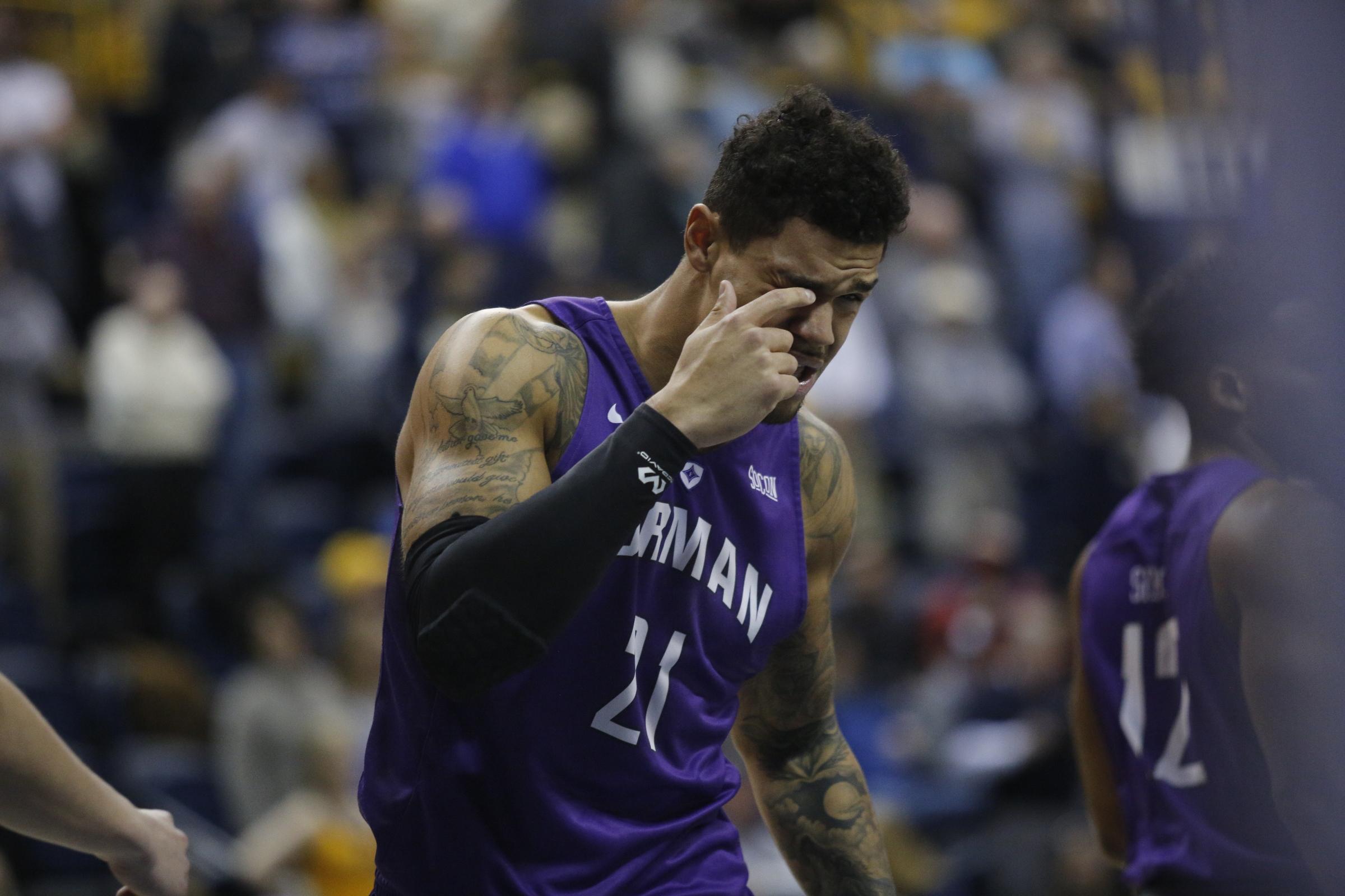 Furman forward Kris Acox grabs his eye after a foul during the Mocs' home basketball game against Furman at McKenzie Arena on Saturday, Jan. 7, 2017, in Chattanooga, Tenn.