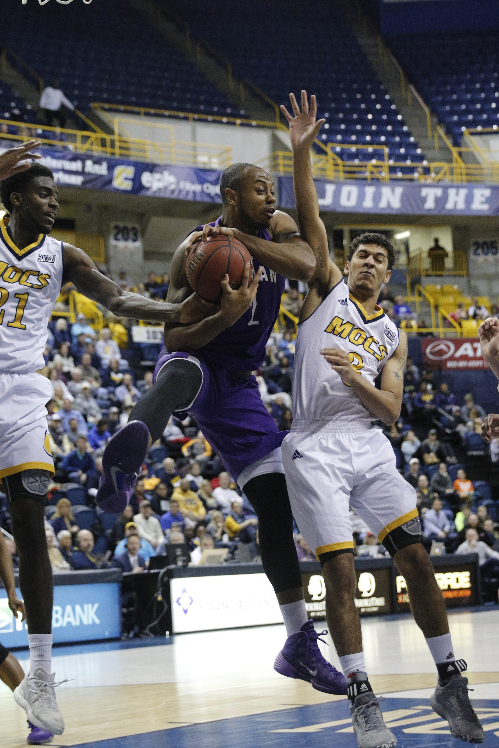 Furman forward Jalen Williams rebounds ahead of UTC guard Nat Dixon during the Mocs' home basketball game against Furman at McKenzie Arena on Saturday, Jan. 7, 2017, in Chattanooga, Tenn.