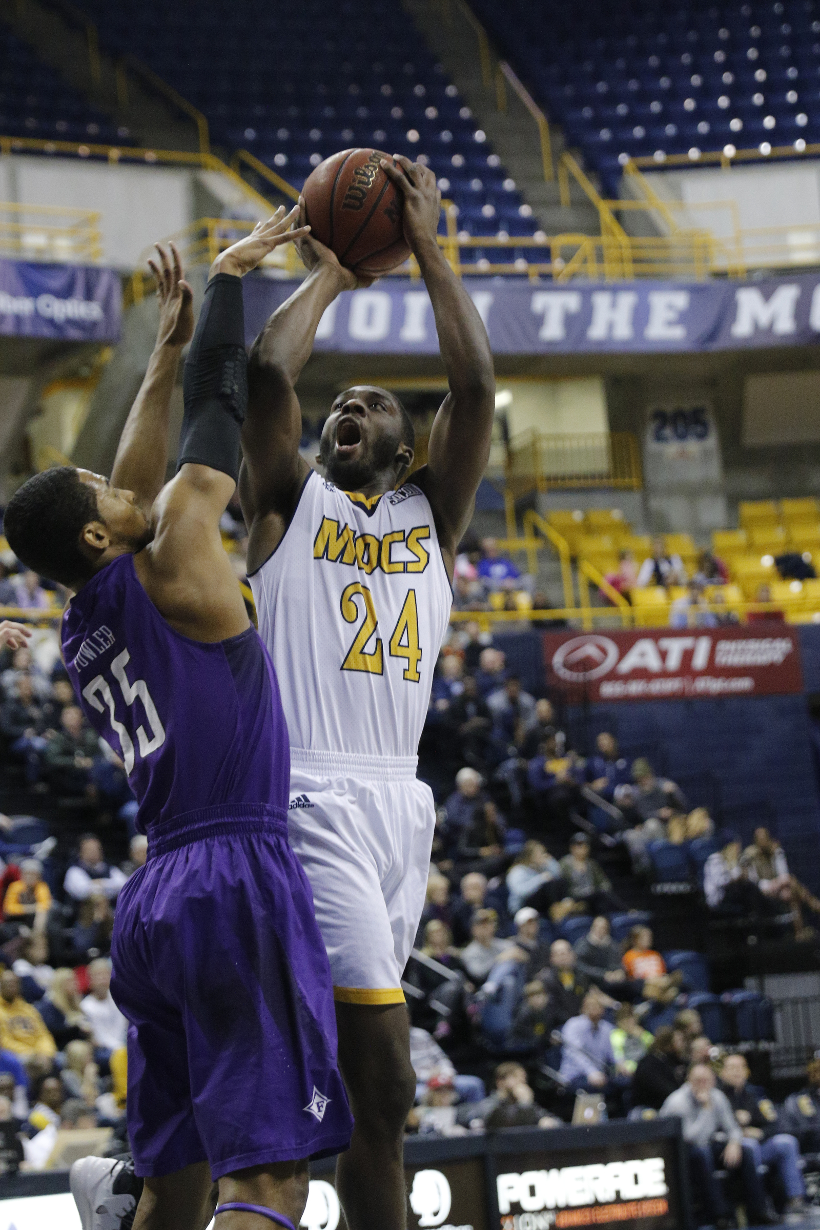 UTC guard Casey Jones shoots a 3 over Furman guard Daniel Fowler during the Mocs' home basketball game against Furman at McKenzie Arena on Saturday, Jan. 7, 2017, in Chattanooga, Tenn.