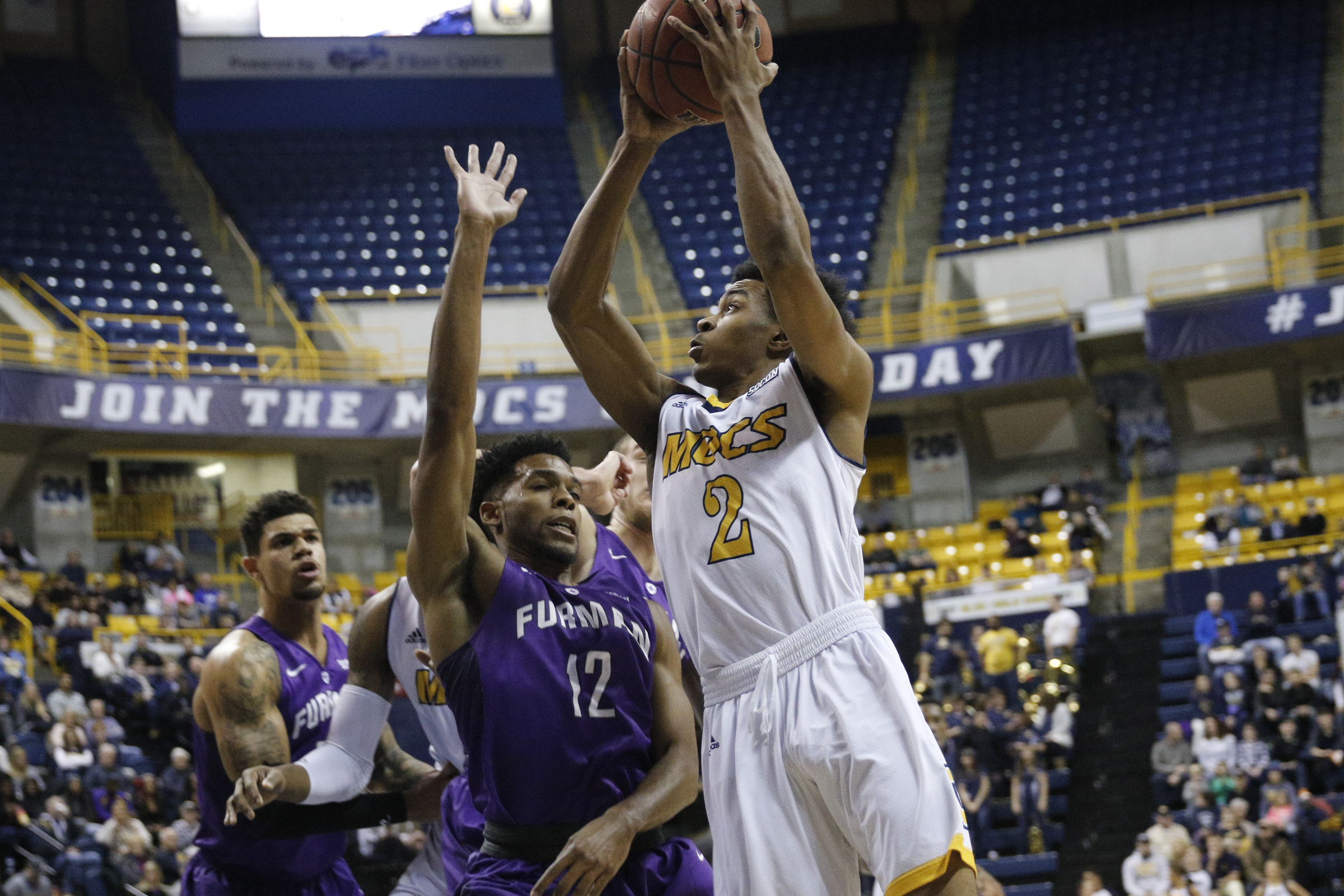 UTC guard Rodney Chatman shoots around Furman forward Devin Sibley during the Mocs' home basketball game against Furman at McKenzie Arena on Saturday, Jan. 7, 2017, in Chattanooga, Tenn.