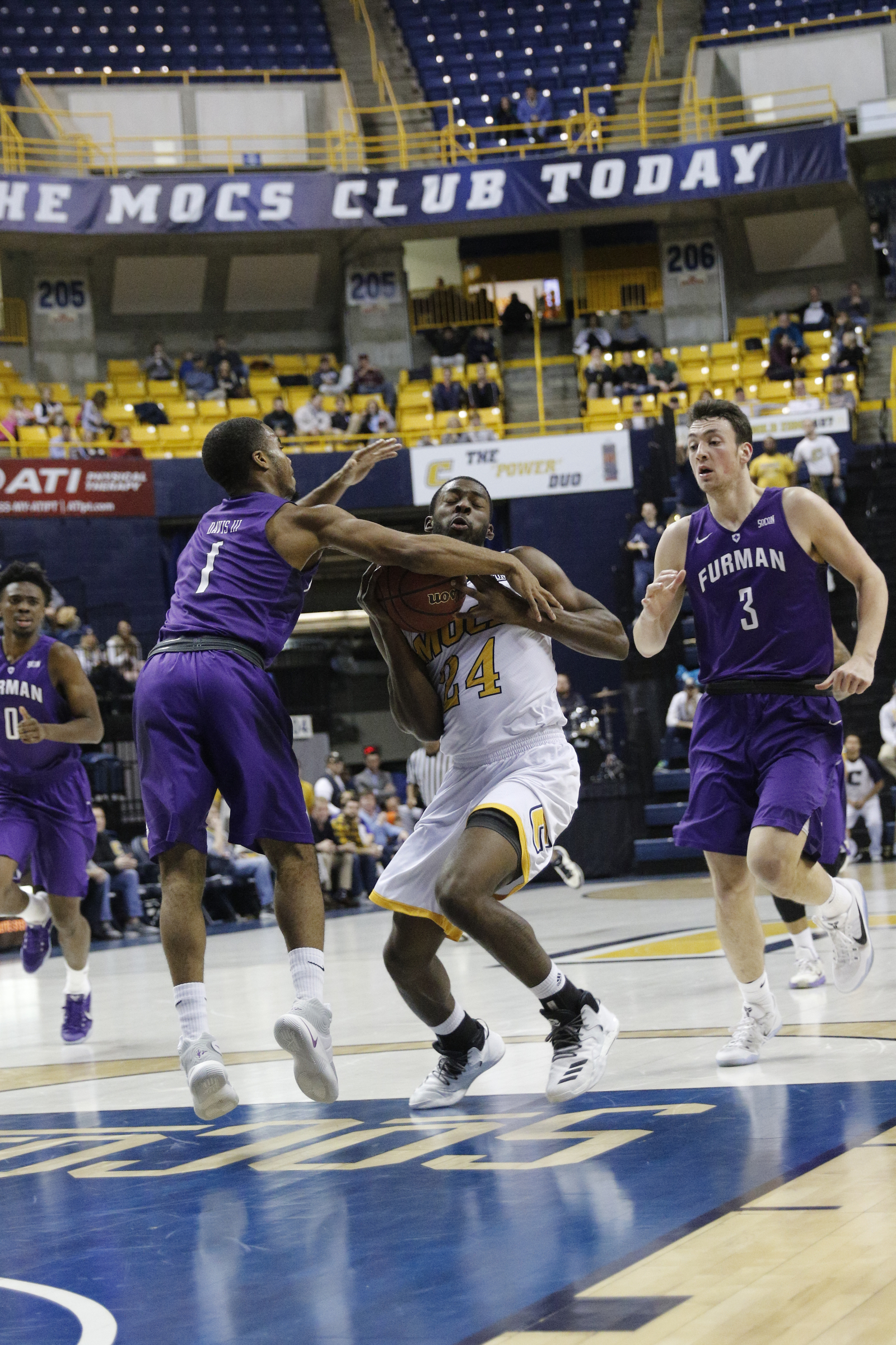 UTC guard Casey Jones runs into the arm of Furman guard John Davis III during the Mocs' home basketball game against Furman at McKenzie Arena on Saturday, Jan. 7, 2017, in Chattanooga, Tenn.