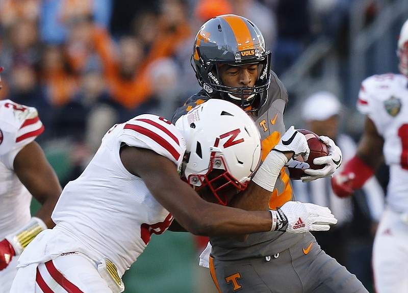 Tennessee wide receiver Josh Malone is hit by Nebraska defender Chris Jones in the first half of the Vols' Music City Bowl game against the Nebraska Cornhuskers at Nissan Stadium on Friday, Dec. 30, 2016, in Nashville, Tenn. Tennessee won 38-24.