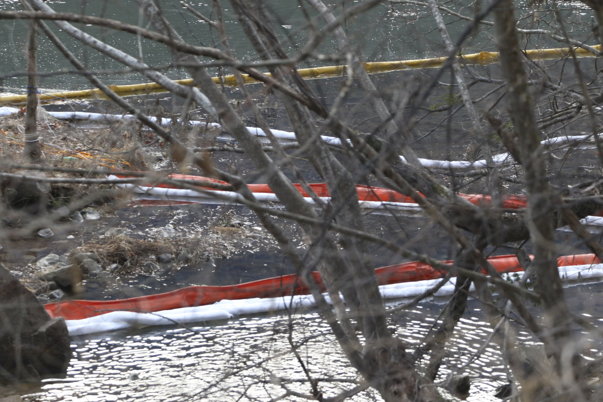 Staff Photo by Dan Henry / The Chattanooga Times Free Press- 1/8/17. Absorbent booms are set up as Colonial pipeline group personnel and emergency workers search for a liquid gas leak along Shoal Creek near the suck Creek boat ramp on Sunday, January 8, 2017.