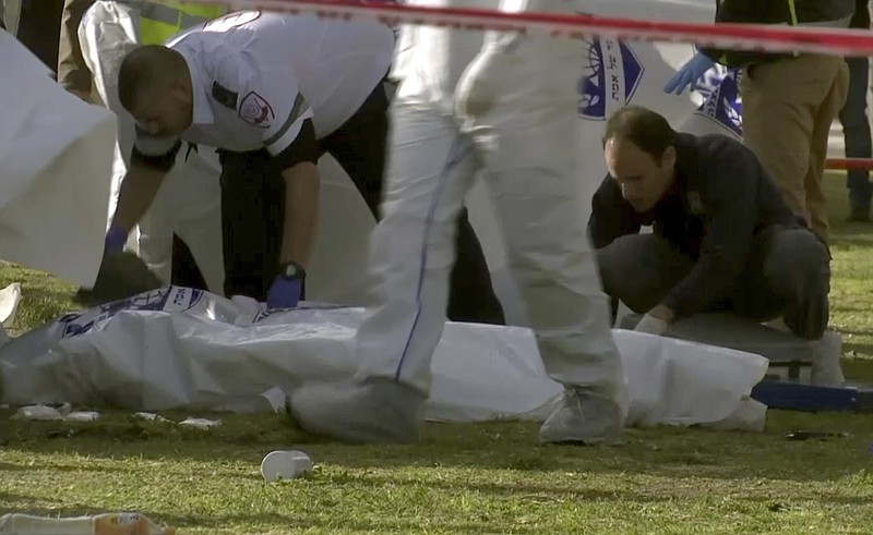 
              This frame grab from video, shows Israeli emergency services personnel covering bodies with plastic sheets at scene of a truck-ramming attack in Jerusalem that killed at least four people and wounded several others in Jerusalem, Sunday, Jan. 8, 2017. Israeli police and rescue services said a Palestinian rammed his truck into a group of Israeli soldiers in one of the deadliest attacks of a more than yearlong campaign of violence. Security camera footage shows the truck barreling at a high speed off the road and into a crowd of people in the Armon Hanatziv neighborhood. (AP Photo)
            