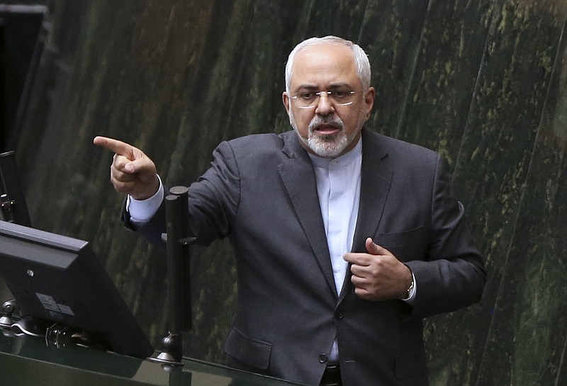 
              FILE - In this file photo dated Sunday, Oct. 2, 2016, Iranian Foreign Minister Mohammad Javad Zarif answers questions from lawmakers in an open session of parliament in Tehran, Iran, explaining the nuclear deal with world powers.  Iran is to receive a huge shipment of natural uranium from Russia to compensate it for exporting tons of reactor coolant, according to unidentified Iranian diplomats Monday Jan. 9, 2017, in a move approved to keep Tehran committed to a landmark nuclear pact.  (AP Photo/Vahid Salemi, FILE)
            