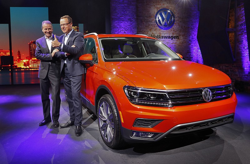 
              Herbert Diess, left, Member of the Board of Management of Volkswagen AG, Chairman of the Board of Management of the Volkswagen Passenger Cars brand and Hinrich Woebcken, right, CEO of the North America Region, Volkswagen and President and CEO of Volkswagen Group of America, Inc. pose after unveiling the Volkswagen Tiguan before the North American International Auto Show in Detroit, Sunday, Jan. 8, 2017. (AP Photo/Paul Sancya)
            
