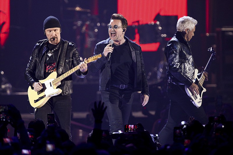 
              FILE - In this Sept. 23, 2016, file photo, The Edge, from left, Bono and Adam Clayton of the music group U2 perform at the 2016 iHeartRadio Music Festival at T-Mobile Arena in Las Vegas. U2 announced Jan. 9, 2017, that it will play the entirety of its classic 1987 album “The Joshua Tree” at each stop during a summer stadium tour to celebrate the 30th anniversary of its release. (Photo by John Salangsang/Invision/AP, File)
            