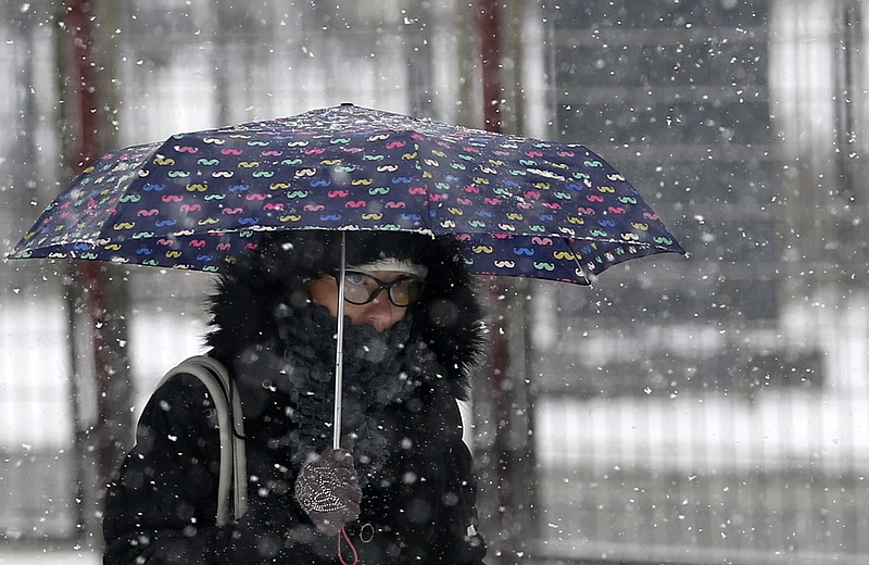 
              A woman shelters from snowfall with an umbrella as she walks through the street on a cold winter day in Belgrade, Serbia, Monday, Jan. 9, 2017. With temperatures dropping to -30 degrees Celsius (-22 Fahrenheit) Serbian authorities have declared emergency measures in nine municipalities in central and southern parts of the country as fresh snow and extremely low temperatures have blocked roads and cut off villages.  (AP Photo/Darko Vojinovic)
            
