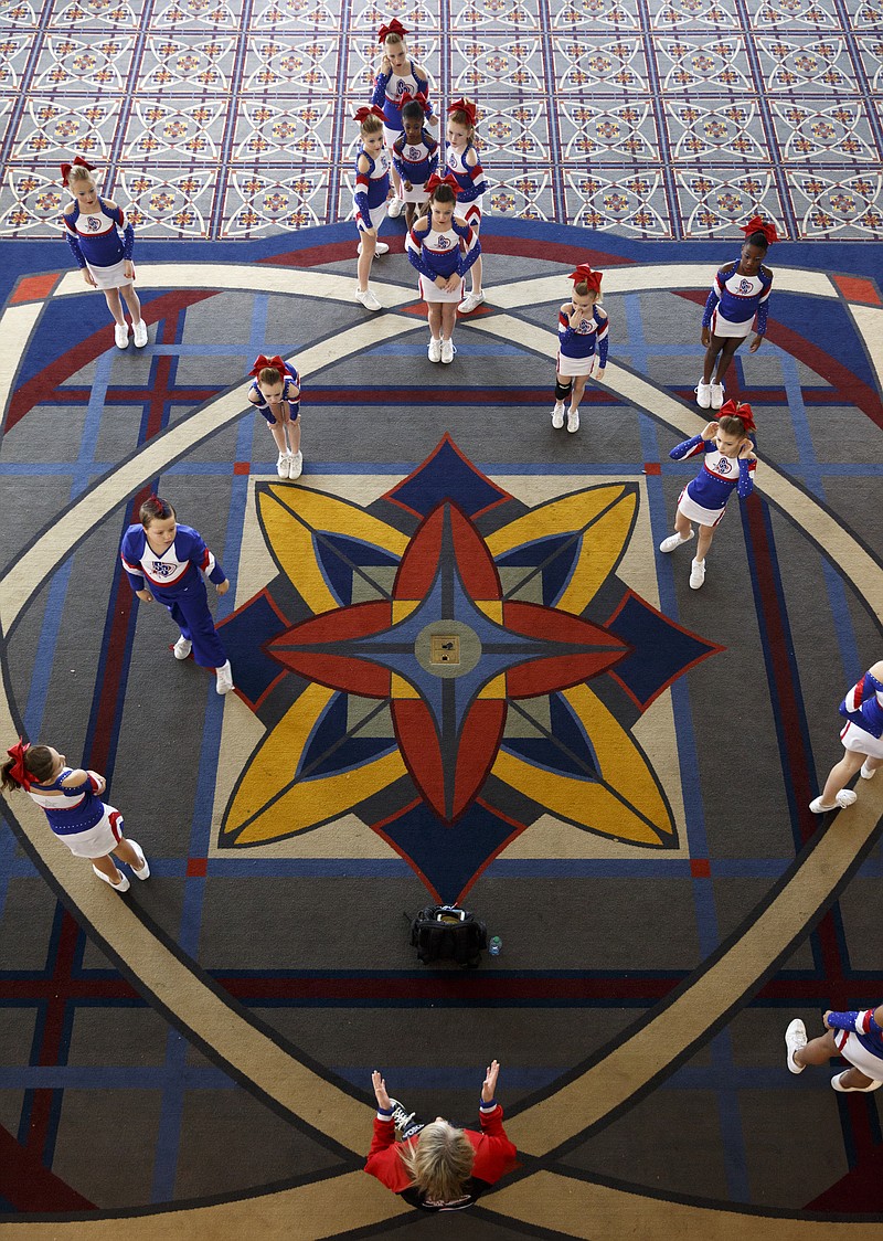 Kelly Dutton, bottom, leads the Southern Spirit Cheer Academy from Decatur, Ala., in warm-ups in the hall outside last year's Athletic Championships cheerleading and dance competition.