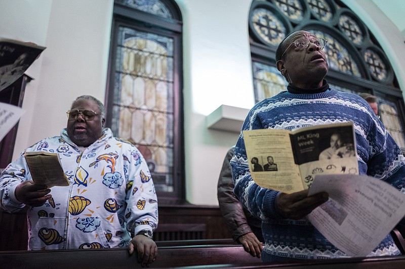 Leonard Rowe, right, and Sherman Matthews sing along with "Lift Every Voice and Sing!" during an interfaith celebration in honor of Martin Luther King, Jr., at Mercy Junction Justice & Peace Center on Tuesday, Jan. 10, 2017, in Chattanooga, Tenn. The celebration is the first of five days of events to honor the late Dr. King.