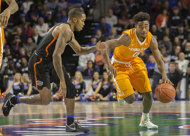 Tennessee guard Jordan Bone (0) dribbles past Florida guard Kasey Hill (0) during the second half of an NCAA college basketball game in Gainesville, Fla., Saturday, Jan. 7, 2017. (AP Photo/Ron Irby)