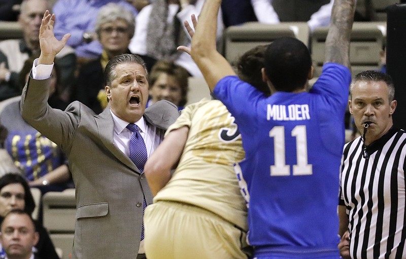 Kentucky coach John Calipari, left, watches from the bench during the first half of the team's NCAA college basketball game against Vanderbilt on Tuesday, Jan. 10, 2017, in Nashville, Tenn. (AP Photo/Mark Humphrey)
