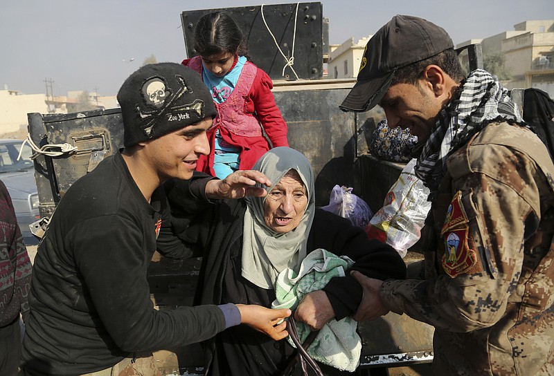 
              Elite counterterrorism forces transport civilians fleeing their homes during fighting between Iraqi security forces and Islamic State militants in Mosul, Iraq, Monday, Jan. 9, 2017. (AP Photo/ Khalid Mohammed)
            