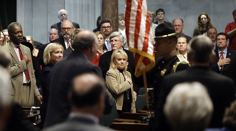 
              Senate members and guests salute the flag as it is carried through the Senate chamber Tuesday, Jan. 10, 2017, in Nashville, Tenn. State lawmakers convened for the 110th Tennessee General Assembly with new leadership in the Senate and a House speaker eying a gubernatorial bid. (AP Photo/Mark Humphrey)
            