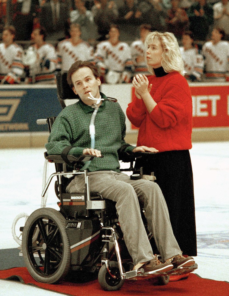 
              FILE - In this Dec. 22, 1987 file photo, New York City Police Officer Steven McDonald, who was shot in the line of duty, is honored on the ice at the Philadelphia Flyers-New York Rangers hockey game in New York's Madison Square Garden with his wife Patti.   McDonald, who was paralyzed by a bullet and became an international voice for peace after he publicly forgave the gunman, died Tuesday, Jan 10, 2017 at the age of 59.  (AP Photo/Wilbur Funches, File)
            