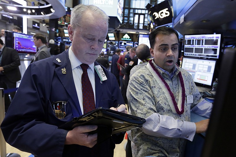 
              Trader James Riley, left, and specialist Dilip Patel work on the floor of the New York Stock Exchange, Tuesday, Jan. 10, 2017. The stock market is getting off to a mixed start as drops in real estate and utilities offset gains in other sectors including health care. (AP Photo/Richard Drew)
            