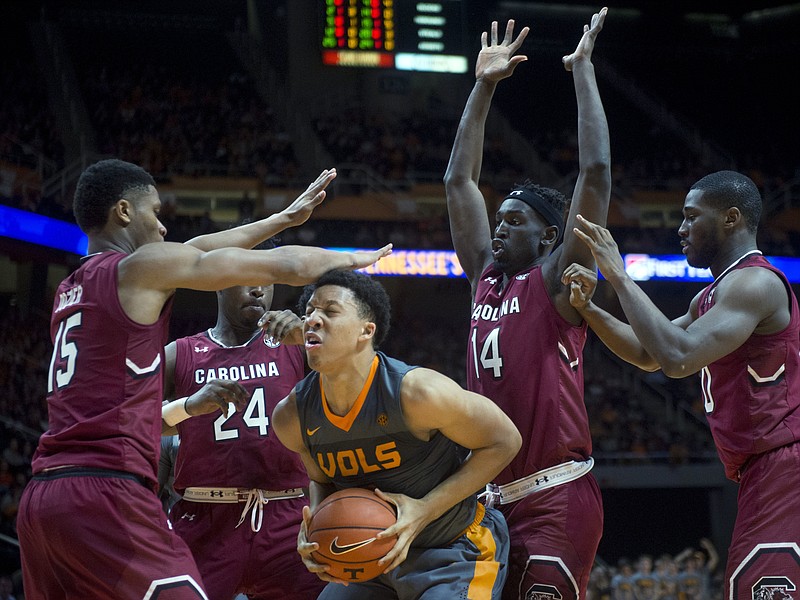 Tennessee's Grant Williams is pressured South Carolina's PJ Dozier, Sedee Keita, Ran Tut, and Justin McKie, from left, during an NCAA college basketball game in Knoxville, Tenn., Wednesday, Jan. 11, 2017. (Saul Young/Knoxville News Sentinel via AP)