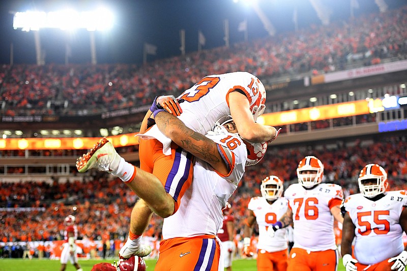 Clemson receiver Hunter Renfrow gets a hug from tight end Jordan Leggett after Renfrow's winning touchdown catch with one second remaining in Clemson's 35-31 victory over Alabama in Monday night's national championship game in Tampa, Fla.