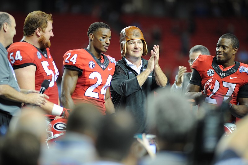 Georgia football coach Kirby Smart celebrates with center Brandon Kublanow (54), safety Dominick Sanders (24) and tailback Nick Chubb (27) following this past season's opening win over North Carolina in the Chick-fil-A Kickoff Game.