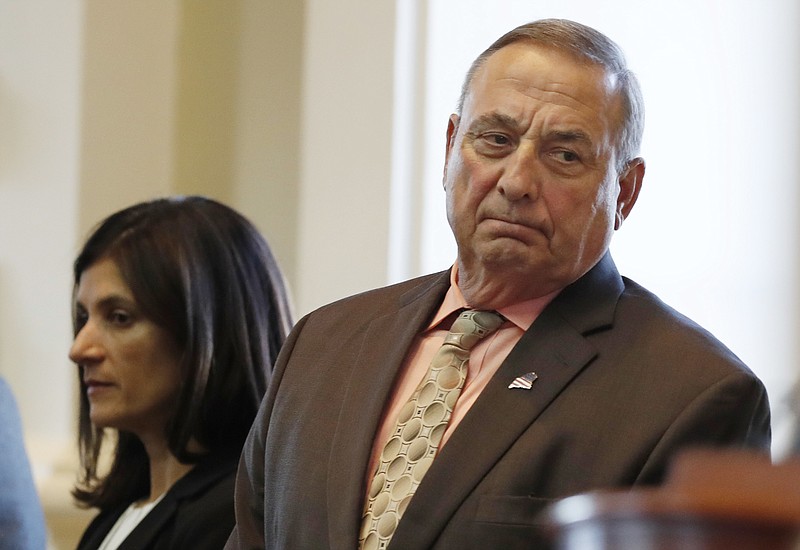 
              FILE - In this Monday, Dec. 19, 2016 file photo Maine Republican Gov. Paul LePage, right, and House Speaker Sara Gideon, D-Freeport, attend the Electoral College vote at the State House in Augusta, Maine. LePage says he had weight loss surgery and jokes that now "there's 50 less pounds of me to hate." The Republican revealed the bariatric surgery for the first time Wednesday, Jan. 11. He says he underwent the procedure on Sept. 29 and returned to work a day later. (AP Photo/Robert F. Bukaty)
            