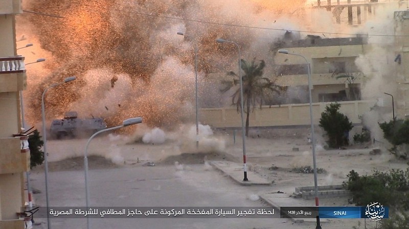 
              This photo posted on a file sharing website Wednesday, Jan. 11, 2017, by the Islamic State Group in Sinai, a militant organization, shows an explosion as militants attack an Egyptian police checkpoint on Monday, Jan. 9, 2017, in el-Arish, north Sinai, Egypt. An Israeli defense official said Wednesday  that the country has developed a new policy in recent years to allow Egypt to quickly beef up its forces in the volatile Sinai peninsula as part of a shared struggle against Islamic militants. The comments came days after Egyptian President Abdel-Fatteh el-Sissi said there are about 25,000 Egyptian troops operating in Sinai. Arabic reads, "The moment a car bomb explodes next to an Egyptian Police fire station checkpoint." (Islamic State Group in Sinai, via AP)
            