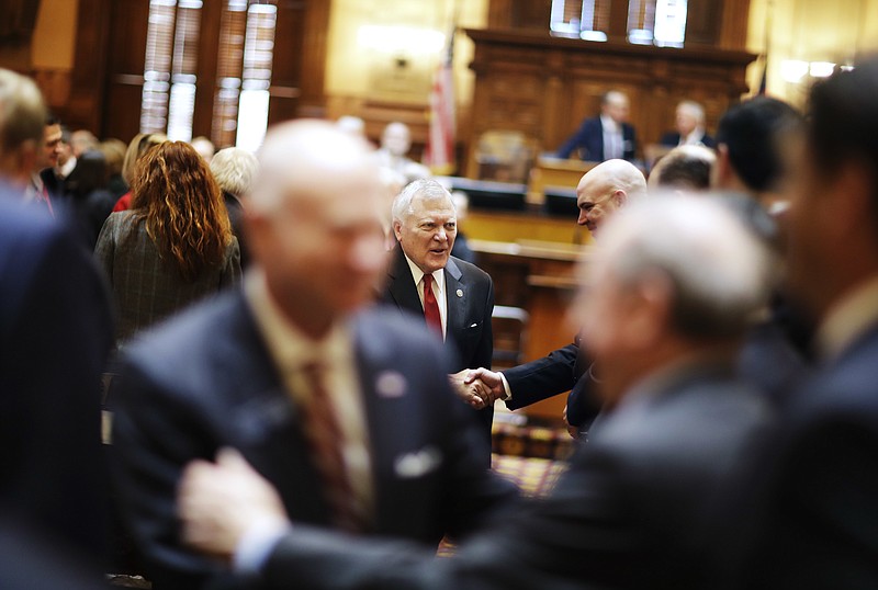 
              Georgia Gov. Nathan Deal shakes hands as he leaves the House floor after delivering the State of the State address in Atlanta, Wednesday, Jan. 11, 2017. Deal is asking Georgia lawmakers to support a new plan for fixing low-performing schools after voters last fall rejected a proposal for state takeovers of schools that consistently struggle. The Republican governor said in his State of the State speech Wednesday that nearly 89,000 students were stuck in failing schools last year and their number "will grow with each passing school year" if nothing is done. (AP Photo/David Goldman)
            