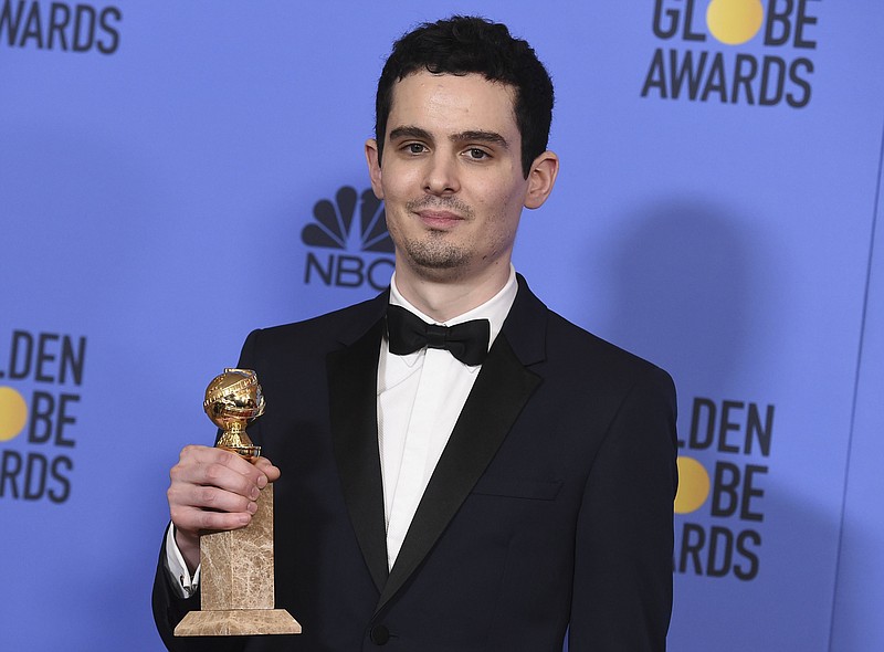 
              FILE - This Jan. 8, 2017 file photo shows Damien Chazelle, director and screenwriter for "La La Land," in the press room with the award for best screenplay - motion picture at the 74th annual Golden Globe Awards in Beverly Hills, Calif. Chazelle, “Moonlight’s” Barry Jenkins and "Manchester By The Sea" director Kenneth Lonergan all scored their first ever Directors Guild Award nominations for outstanding directorial achievement for a feature film, Thursday, Jan. 12, 2017. Winners for the 69th annual Directors Guild awards will be announced in Los Angeles on Feb. 4. (Photo by Jordan Strauss/Invision/AP, File)
            