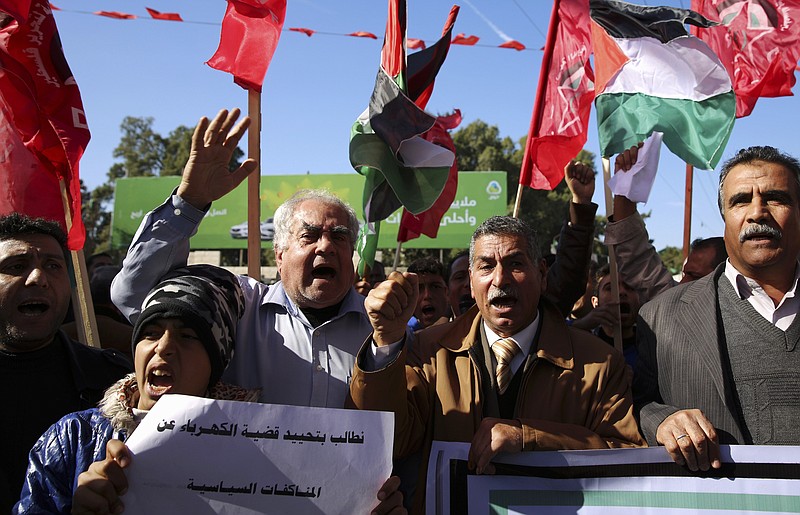 
              Palestinians chant slogans during a protest against the electricity shortages at the main square in Gaza City, Thursday, Jan. 12, 2017. The Palestinian enclave is experiencing worst electricity shortage in years, with power supplied to households only three to four hours in a cold winter. (AP Photo/Adel Hana)
            