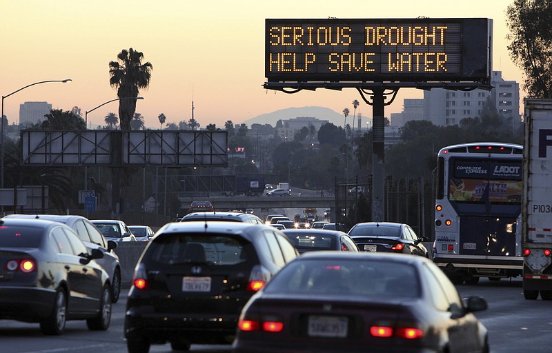 
              FILE - In this Friday, Feb. 14, 2014, file photo, morning traffic makes its way toward downtown Los Angeles along the Hollywood Freeway past an electronic sign warning of severe drought.  More than 40 percent of California has emerged from a punishing drought that covered the whole state a year ago, federal drought-watchers said Thursday, Jan. 12, 2017  a stunning transformation caused by an unrelenting series of storms in the North that filled lakes, overflowed rivers and buried mountains in snow.  (AP Photo/Richard Vogel, File)
            