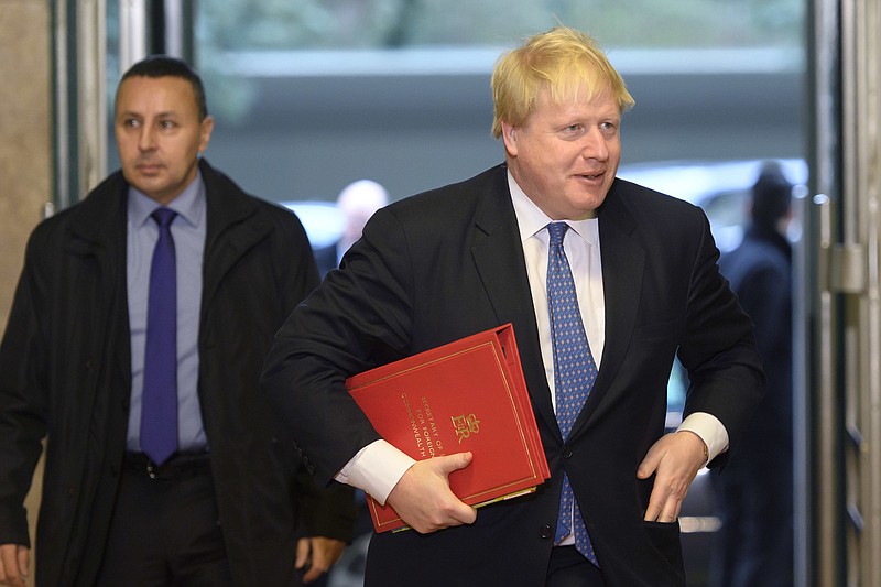 
              British Foreign Secretary Boris Johnson, right, arrives for the conference on Cyprus on the sideline of the Cyprus peace talks at the European headquarters of the United Nations in Geneva, Switzerland, on Thursday, Jan. 12, 2017. (Martial Trezzini/Keystone via AP)
            
