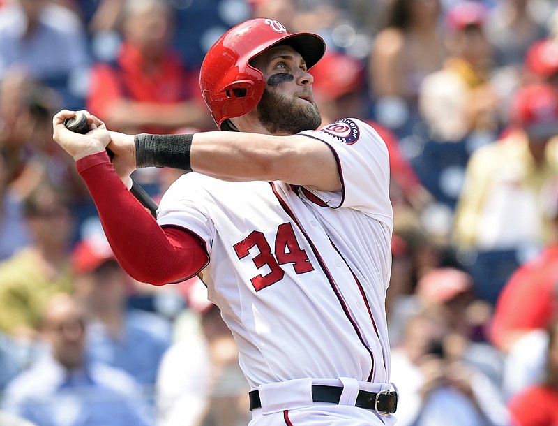 
              FILE - In this May 6, 2015, file photo, Washington Nationals right fielder Bryce Harper watches the ball after hitting a second home run against the Miami Marlins during the third inning of their baseball game at Nationals Park in Washington. Harper, Chicago Cubs pitcher Jake Arrieta, New York Mets pitchers Matt Harvey and Jacob deGrom, and Baltimore third baseman Manny Machado were among 146 players eligible to exchange salary arbitration figures with their teams, though most were expected to reach agreements. (AP Photo/Susan Walsh, File)
            