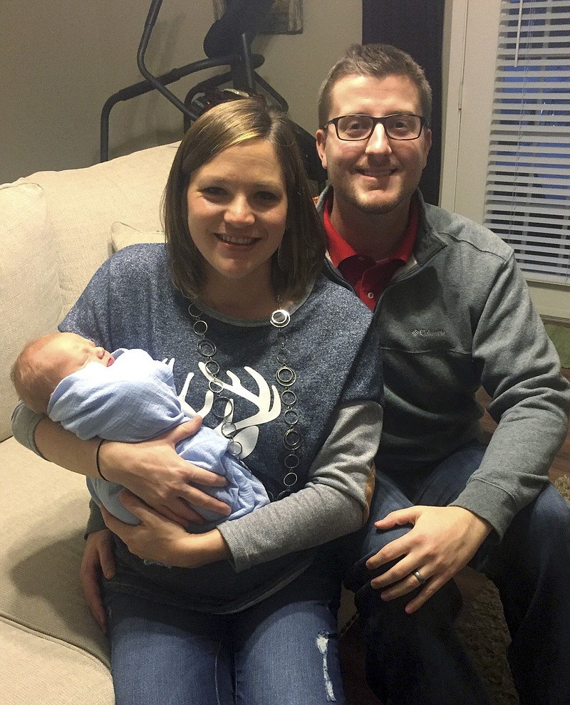 
              In the photo taken Dec. 24, 2016, by Luke Gardner with his cell phone on a timer, Luke and Hillary Gardner pose with their son Cade Lee in Baldwyn, Miss. The husband and wife share the same birthday, and now also their son who was born on Dec. 18. The odds of that happening are about one in 133,000 statisticians say. (Luke Gardner via AP)
            