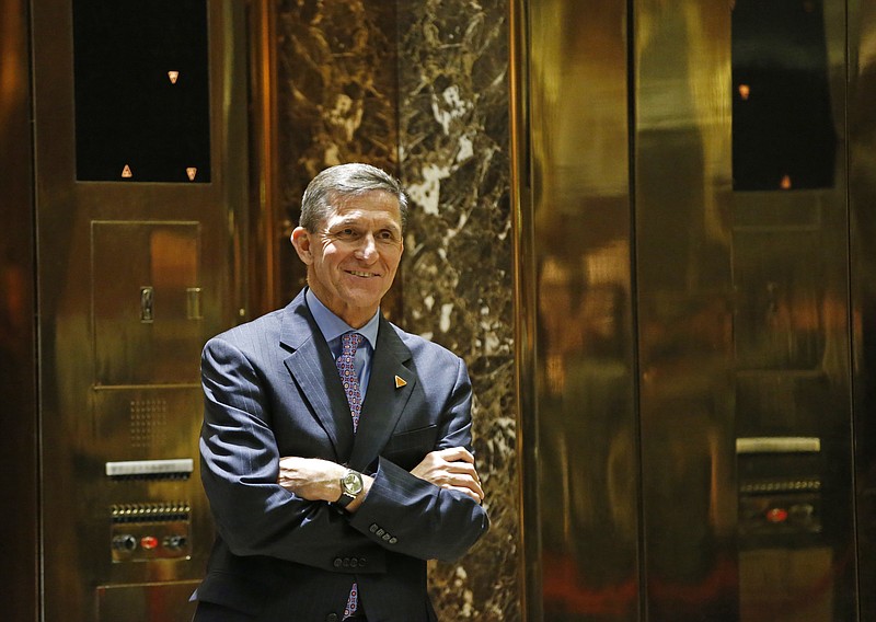 In this Dec. 12, 2016 file photo, National Security Adviser-designate Michael T. Flynn waits for an elevator in the lobby at Trump Tower in New York. The Obama administration is aware of frequent contacts between President-elect Donald Trump's top national security adviser Michael Flynn and Russia's ambassador to the United States, including on the day President Barack Obama hit Moscow with sanctions in retaliation for election-related hacking, a senior U.S. official said Friday, Jan. 13, 2017. (AP Photo/Kathy Willens, File)