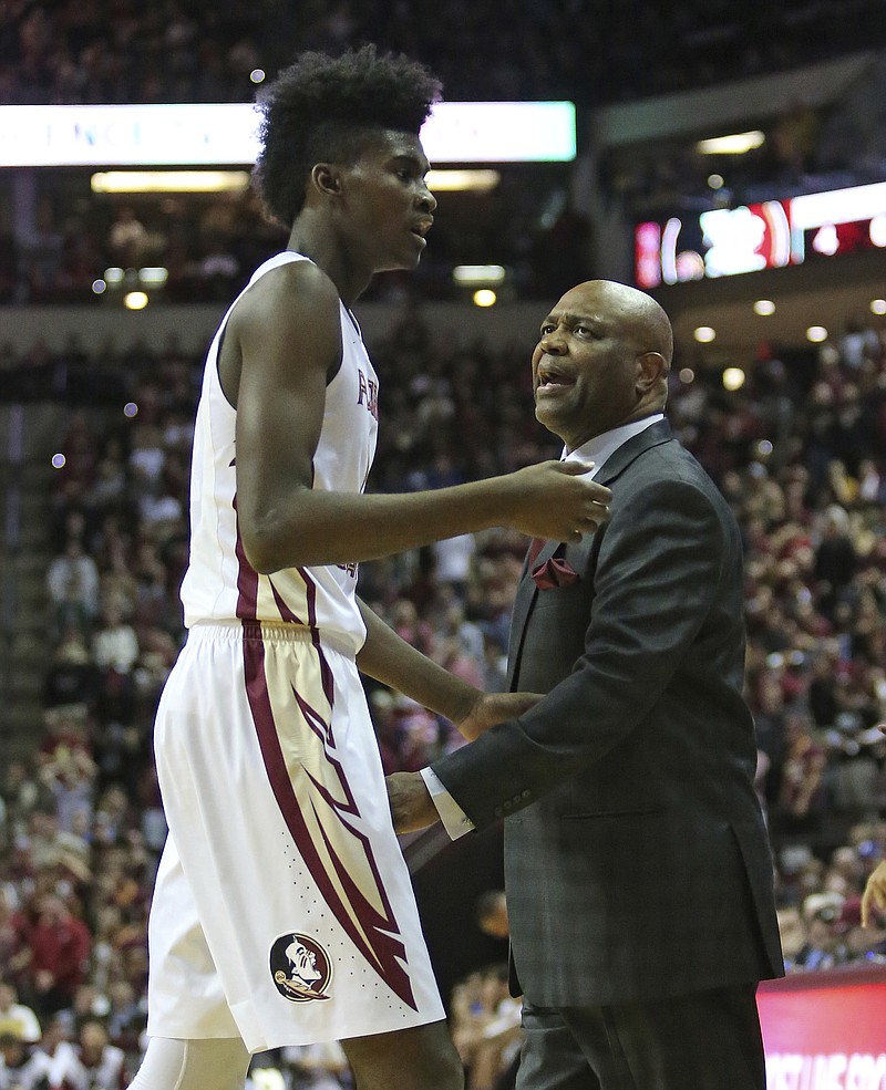 
              Florida State's head coach Leonard Hamilton talks with Johnathan Isaac as he leaves the court in the first half of an NCAA college basketball game, Tuesday, Jan. 10, 2017, in Tallahassee, Fla. Florida State won 88-72. (AP Photo/Steve Cannon)
            